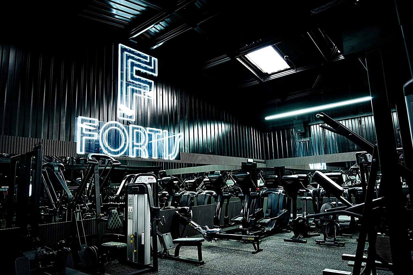 The FORTIS neon sign above the gym floor